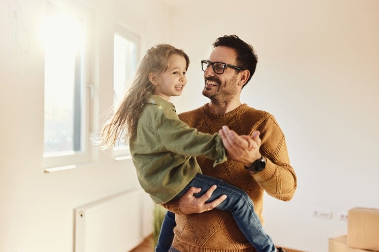Father and child smiling together – heartwarming moment for Father’s Day quotes collection.
